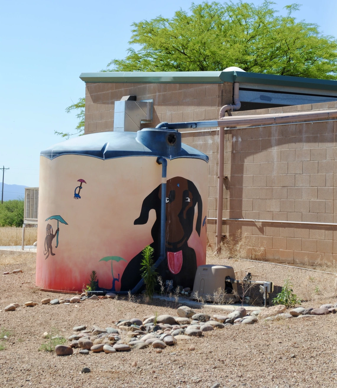 A rainwater tank shows a painting of a dog.